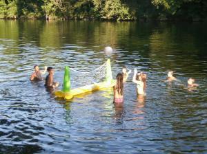 a group of people in a lake with a net at Vacation House Spiritus Flumine in Netretić