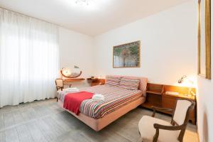 a bedroom with a bed and a desk and a chair at Cappuccini Florence your easy stay close to the center in Florence