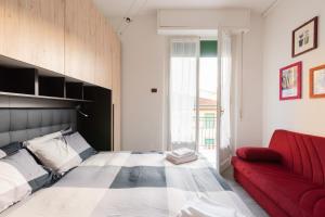 a bedroom with a bed and a red couch at Cappuccini Florence your easy stay close to the center in Florence