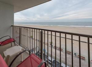 a balcony with a view of the beach at Boardwalk One by Capital Vacations in Ocean City