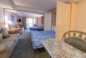 a hotel room with a bed and a couch at Boardwalk One by Capital Vacations in Ocean City