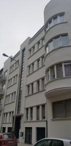 a building with a car parked in front of it at 4CULTURE APART bezpłatny parking in Łódź