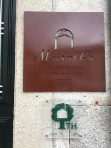 a sign for a chan house on the side of a building at Muralha Charm House in Lamego