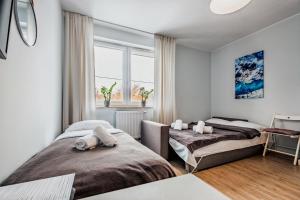 Łóżko lub łóżka w pokoju w obiekcie Apartamenty Novomiejska 17
