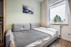 Łóżko lub łóżka w pokoju w obiekcie Apartamenty Novomiejska 17