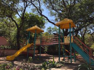 a playground with a slide in a park at Evershine Resort & Spa in Mahabaleshwar