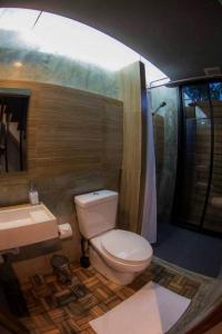 a bathroom with a toilet a sink and a bathtub at In a Box Hostel in Bangkok