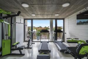 a gym with treadmills and elliptical machines at T Design Hotel Boutique in Tandil