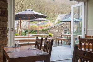 a table with an umbrella on a patio at The Cambrian Inn in Solva
