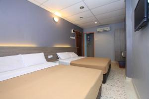 Cama o camas de una habitación en Yellow Mansion Hotel