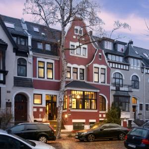 a large building with cars parked in front of it at Monopol Boutique Hotel in Bremen