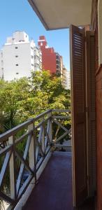 a balcony with a wooden railing in a city at Hotel Luminton in Mar del Plata