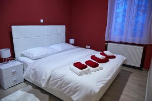 a bedroom with a white bed with towels on it at Station in Osijek