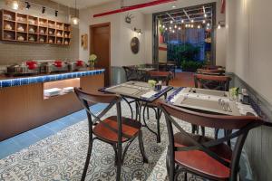 a restaurant with a table and chairs and a counter at Little Saigon Boutique Hotel in Ho Chi Minh City +64 photos
