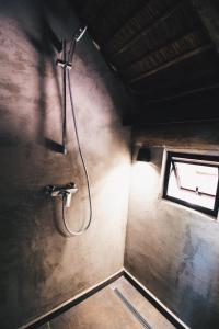 a shower in a bathroom with a window at Tava Cerro in San Bernardino