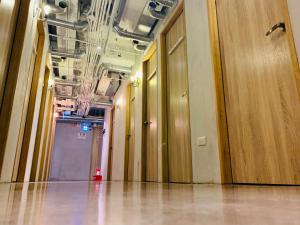 a hallway with wooden doors and floors in a building at WORK INN TPE in Taipei