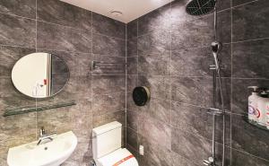 a bathroom with a toilet and a sink and a mirror at If Business Hotel in Changwon +16 photos