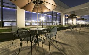 a table and chairs with umbrellas in a building at If Business Hotel in Changwon