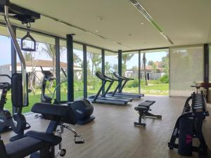 a gym with a bunch of treadmills and ellipticals at Anantara Quy Nhon Villas in Quy Nhon