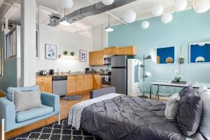 a bedroom with a bed and a table and a kitchen at Trifecta 2BR Free Parking Modern Superhost in Durham