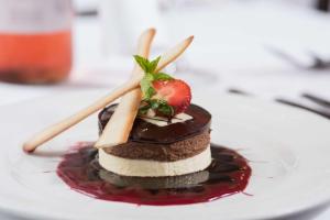 a piece of cake with berries and whipped cream on a plate at The Inveraray Inn, BW Signature Collection in Inveraray