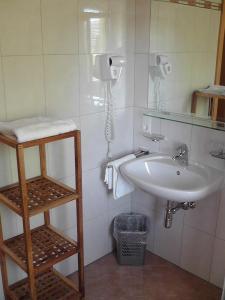 a bathroom with a sink and a mirror at Appartements Jäger in Flachau