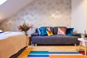 - un salon avec un canapé et des oreillers colorés dans l'établissement Royal Route Residence Lesser Town, à Prague