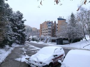 a snow covered car parked on a snowy street at APARTAMENT FOCUS in Gdynia