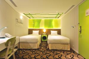 Postel nebo postele na pokoji v ubytování Green World Hotel - Zhonghua
