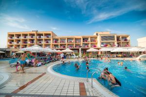 a resort swimming pool with people in the water at Apartment Vita near Terme Paradiso in Dobova