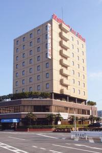 a large building with a sign on top of it at Marroad Inn Tokyo in Fuchu