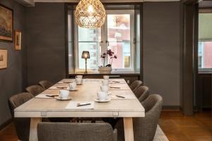 a dining room with a large table and chairs at Victory Apartments in Stockholm