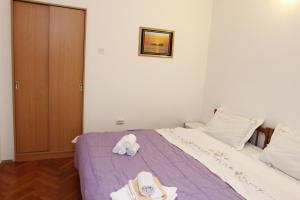 a bedroom with a bed with towels on it at Guest House Olga in Budva