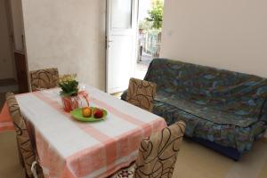 a living room with a table and a couch at Guest House Olga in Budva