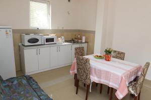 a small kitchen with a table and a microwave at Guest House Olga in Budva