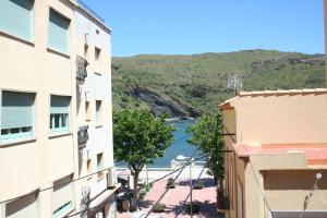 a view of a river from between two buildings at Hostal Juventus in Portbou