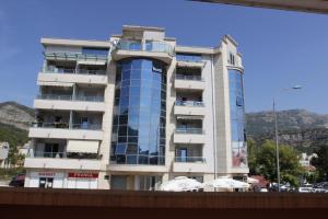 a tall white building with a lot of windows at Guest House Olga in Budva