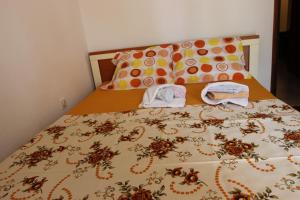 a bed with two towels on top of it at Guest House Olga in Budva