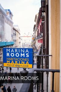 a street with signs on the side of a building at Marina Rooms in Madrid