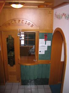 a bar in a restaurant with a sign on the wall at Hotel Negritella in Fai della Paganella