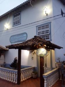 un edificio blanco con un paraguas delante en Pousada Serenna Centro, en Tiradentes