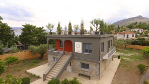 a house with a staircase on the side of it at Boutique Rooms "O" in Orchomenós