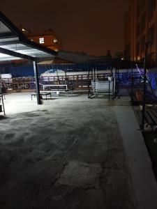 an empty parking lot at night with benches in it at A-Mong B&B (Qingshui) in Qingshui