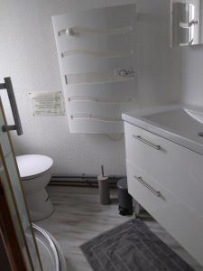a white bathroom with a toilet and a sink at Appartement au calme Centre Ville à 2 pas du vieux marché in La Rochelle