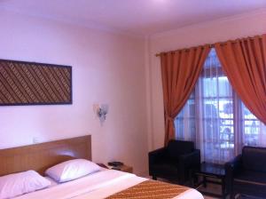 Voodi või voodid majutusasutuse Syariah Arini Hotel toas