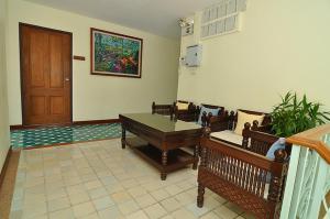 a room with a table and chairs and a door at Sripat Guesthouse SHA Extra Plus in Chiang Mai