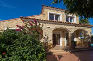 ein Steinhaus mit Garten davor in der Unterkunft Villas Guzman - Romero in Calpe