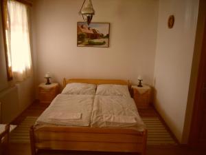A bed or beds in a room at Nosztalgia Vendégház