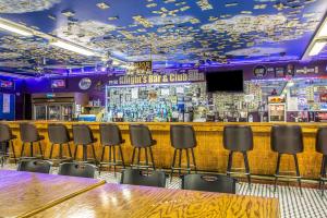 a bar with chairs and a table in a room at Rodeway Inn Bedford in Bedford