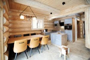 a kitchen with wooden walls and a table and chairs at Summit Lodges in Pfunds